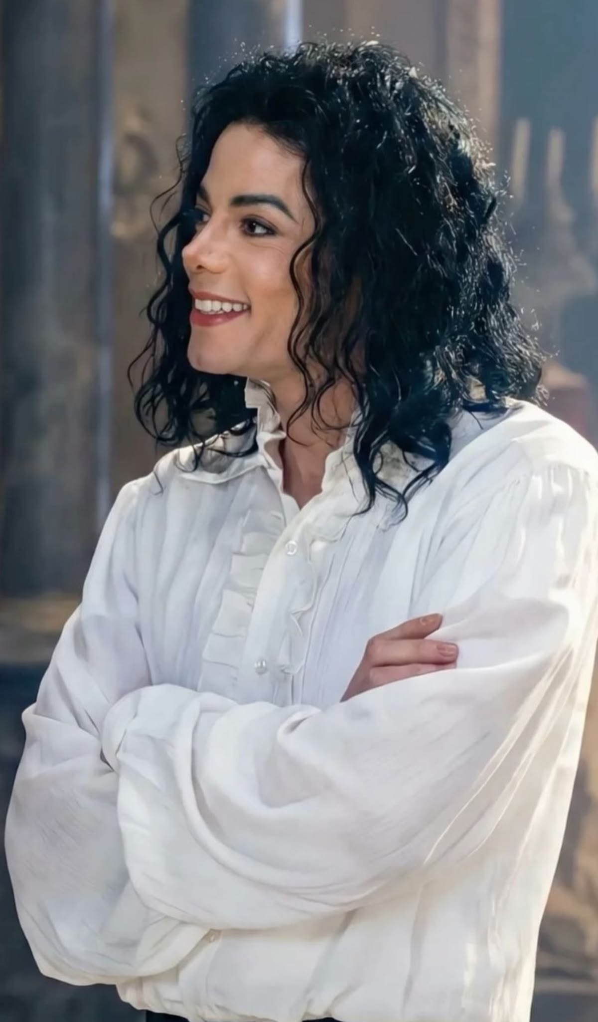 Michael smiling in a white shirt