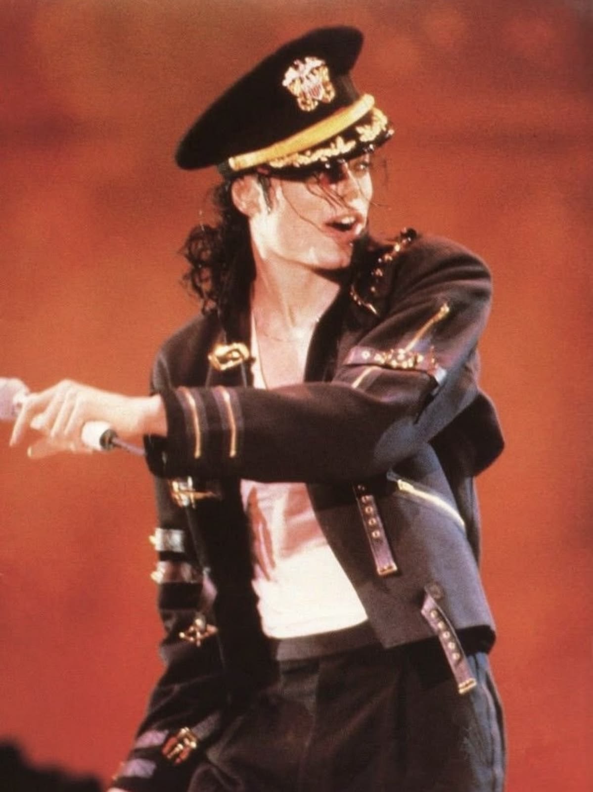 Michael on stage in a military-style jacket